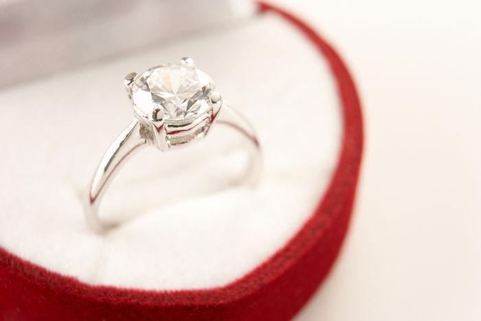 white gold and diamond ring in a red box