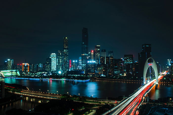 Colored light trails and lights of a sprawling cityscape at night 