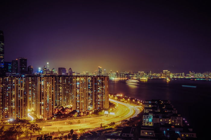 Long exposure shot of a cityscape and light trails at night 