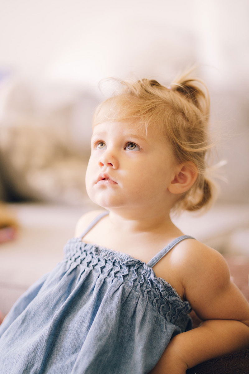 Toddler looking up indoors with natural light