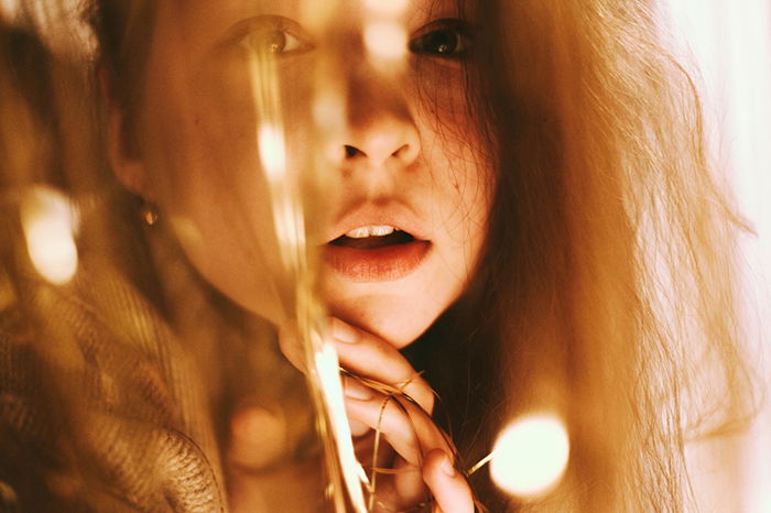 Portrait photo of a girl with red hair in tungsten light