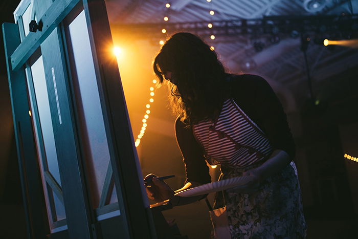 Photo of a waitress writing on a board in tungsten light