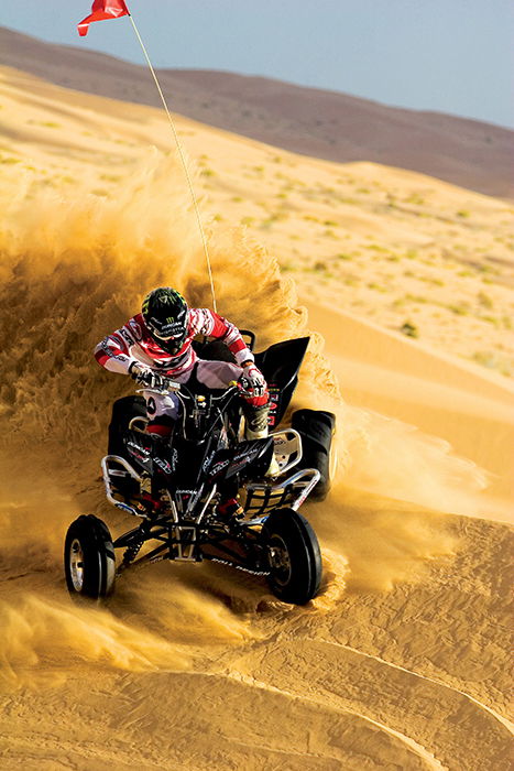 Action shot of a motorsports rider on a beach