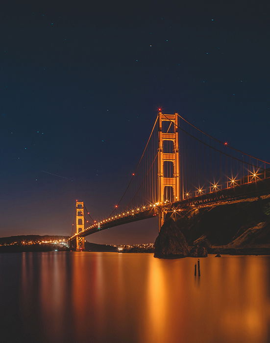 A lit up bridge at night