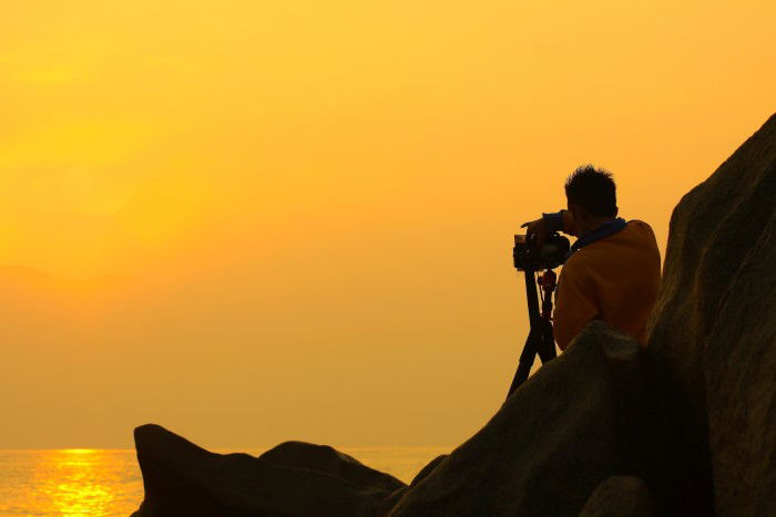 Man taking a sunset time-lapse video 