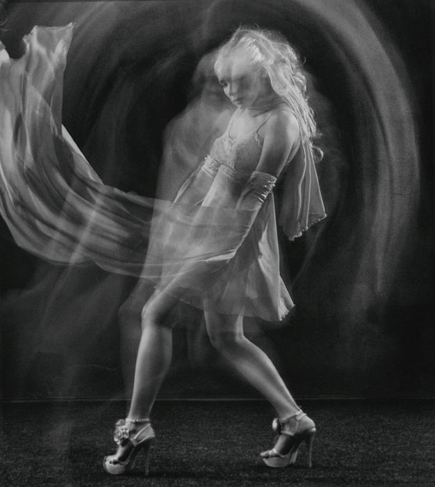 Black and white long exposure of a female dancer onstage 