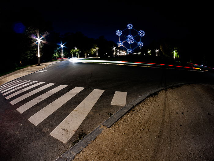 An urban night scene with red light trails caught around a roundabout in Brussels