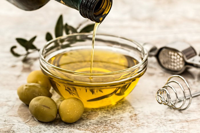 pouring oil into a bowl