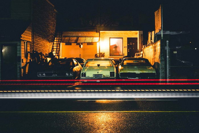 photo of cars parked in front of a house at nighttime