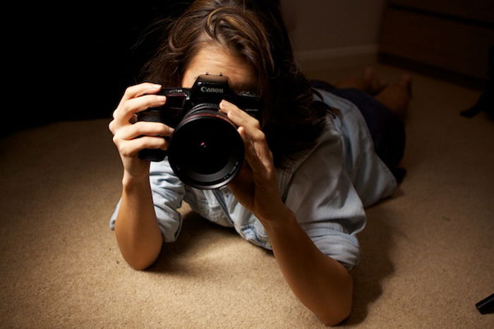 A girl lying down taking a photo