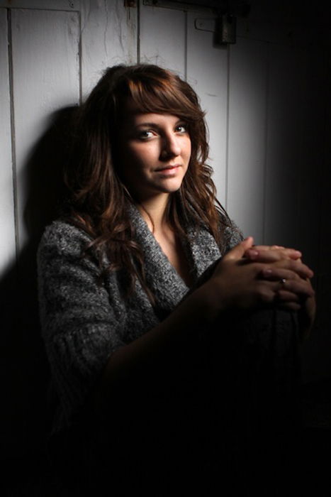 A girl posing in low light