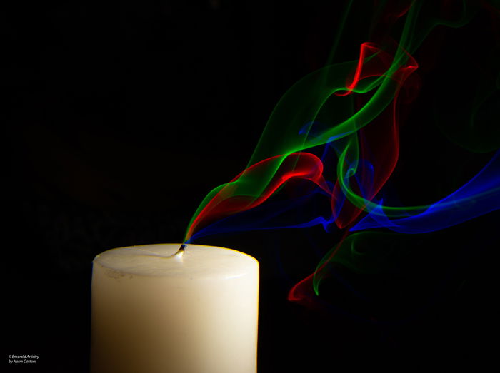 A candle with colorful smoke