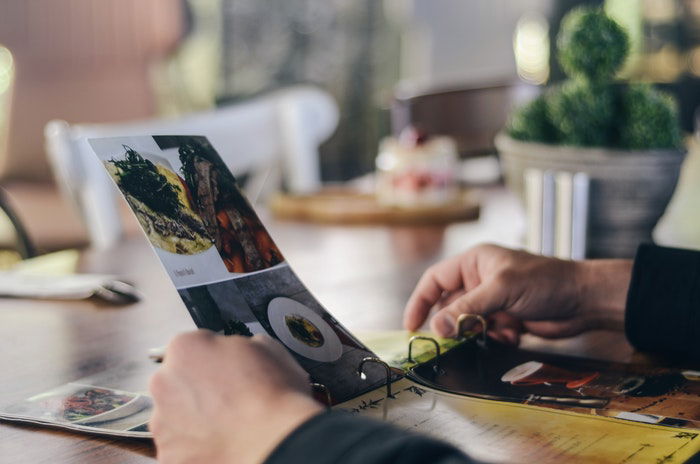 A person looking through a restaurant menu