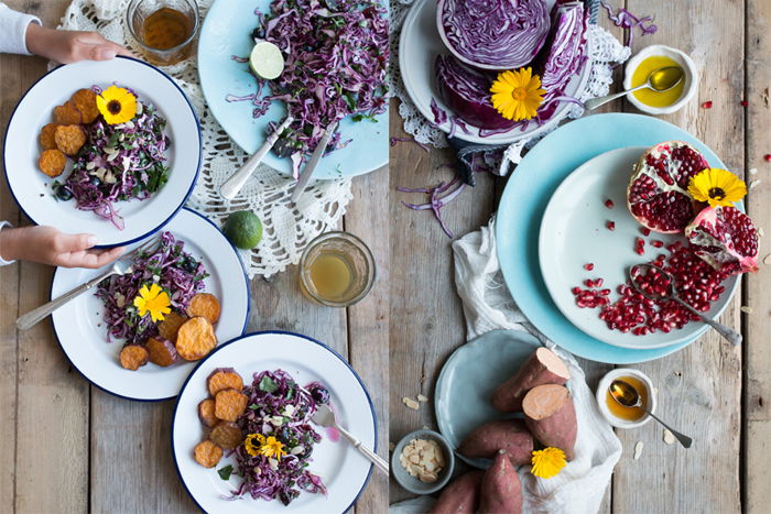 A meal with blue plates, food in bowls and on plates, and fresh garnishes. 