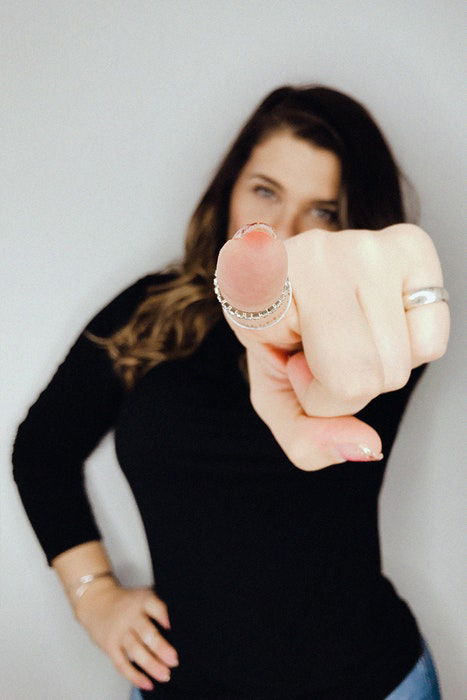 A girl pointing her index finger to the camera