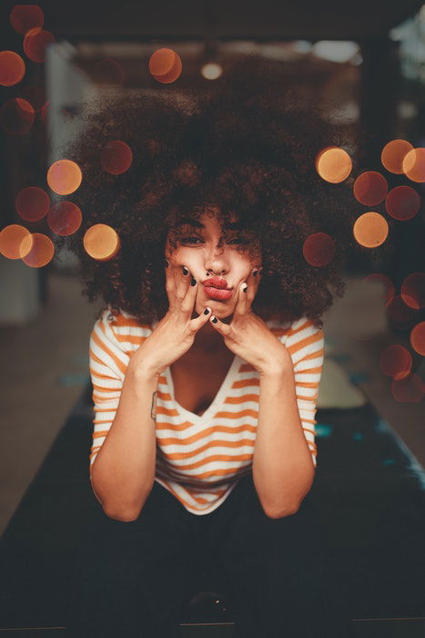 A female model with hands squashing her face