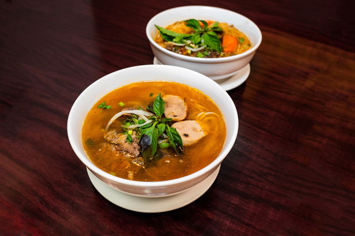 Two bowls of Indian food on a table 