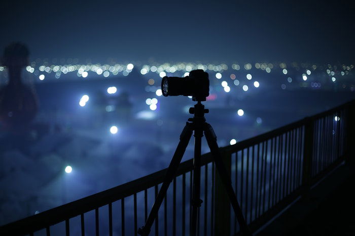 A camera on a tripod at night