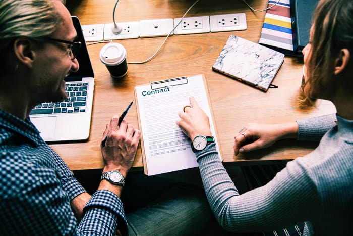 Close up of two people discussing a real estate photography contract