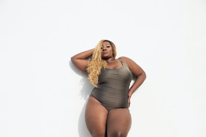 A plus size model poses for boudoir photography