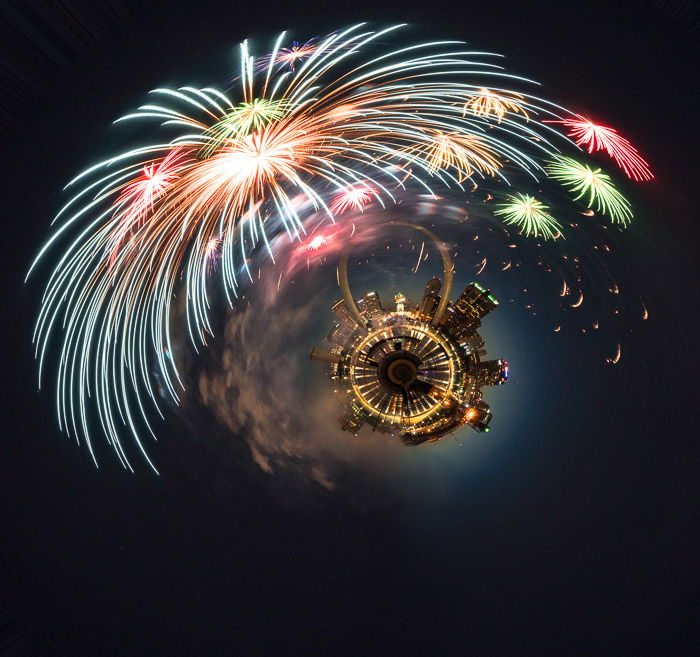 Tiny planet of St. Louis skyline under Independence Day fireworks.