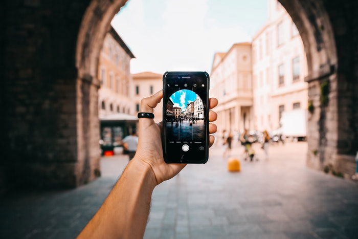 A person taking a smartphone photo of architecture 