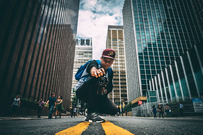 Man taking a photograph in an urban setting