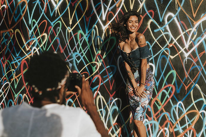 Beautiful model posing by a wall.