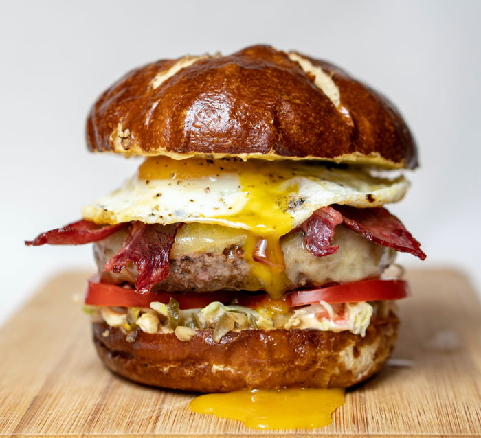 Close-up photo of a delicious burger on a rustic board