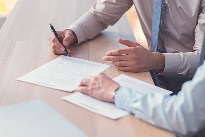 Business people signing a contract on a closeup image.