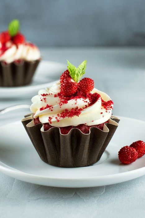 A chocolate muffin with cream frosting