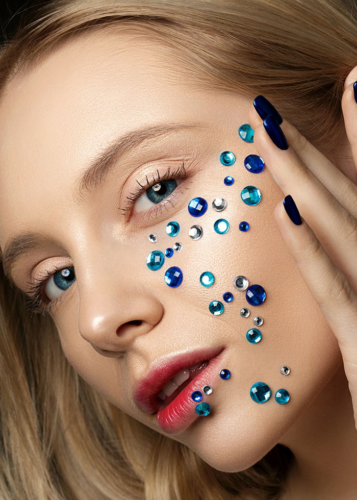 Beautiful high fashion portrait of a woman wearing a unique makeup.