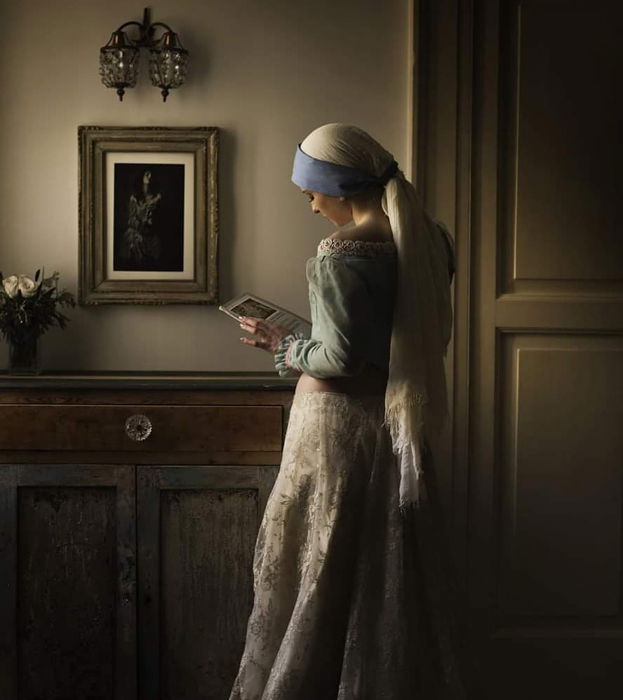 A painterly like portrait of a woman looking at a book in a foyer by fine art photographer Damiano Errico