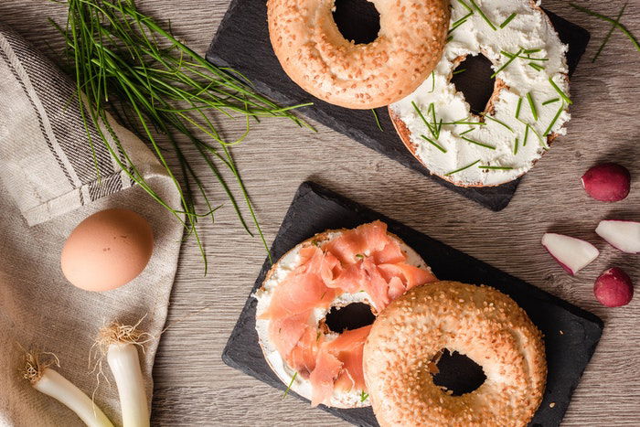 Flat lay food photo of salmon bagels and other ingredients 