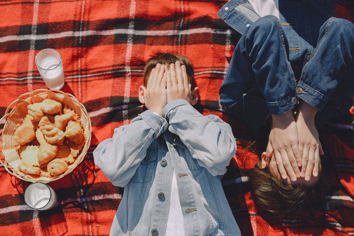 Overhead shot of playful kids on a picnic blanket