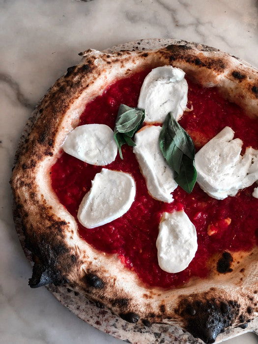 Overhead shot of a pizza with slices of mozzarella