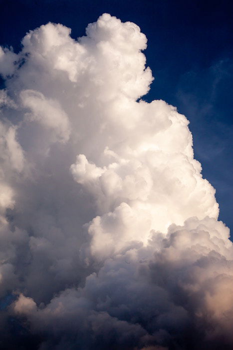 A zoomed-in image of a large cloud against a blue sky