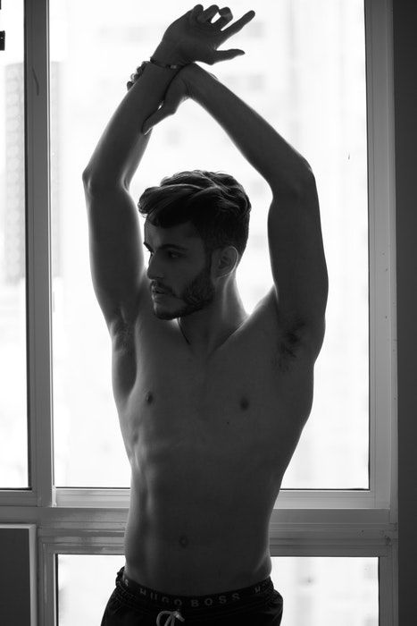 Black and white photo of a half naked male model