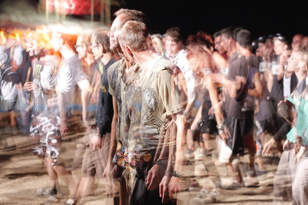 A blurry shot of a group of people walking at night taken with slow shutter speed