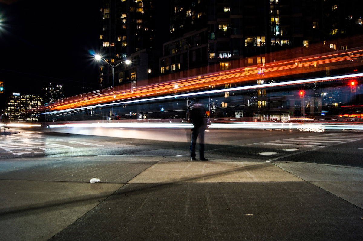 Long-exposure image of person on a city street at night