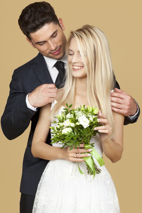 A bride and groom posing for a formal portrait