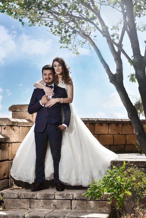 A bride and groom posing outdoors