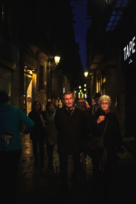 People walking through busy streets at night