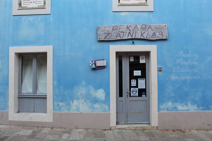 a photo of a door within a blue building shot with a Canon 1300D