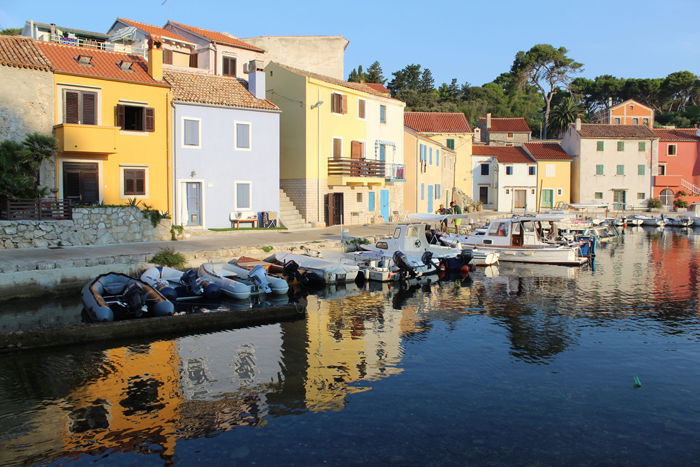 an image of boats docked in front of colorful houses