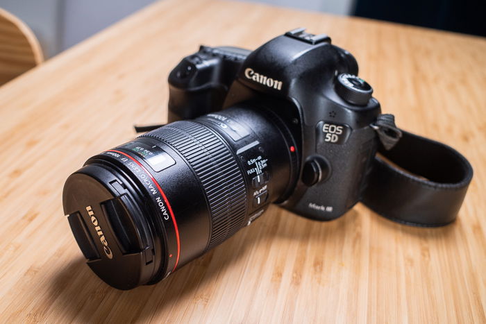 photo of the Canon EF 100mm f/2.8L attached to a camera body