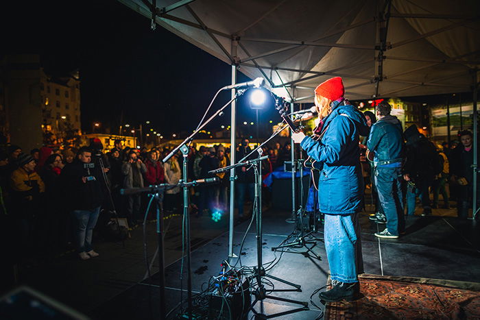 A band performing at an outdoor event at night 