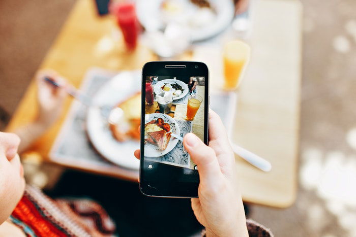 A smartphone being used to capture food photography