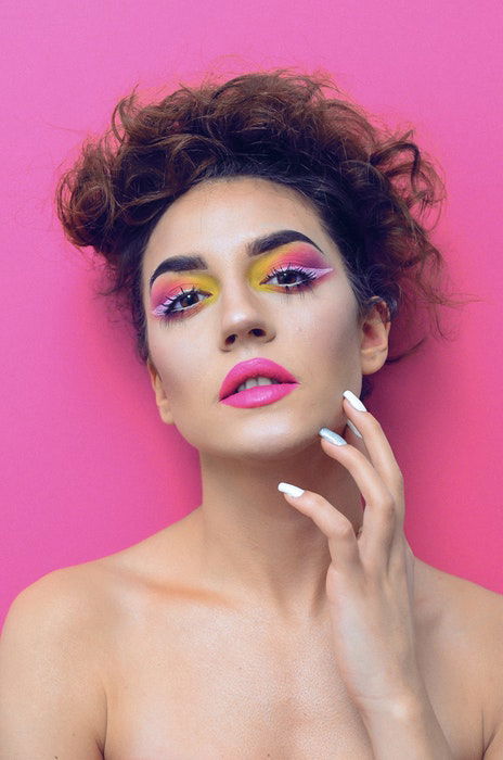 A close-up fashion image of a a woman with colorful makeup using a 1 light setup for portraits