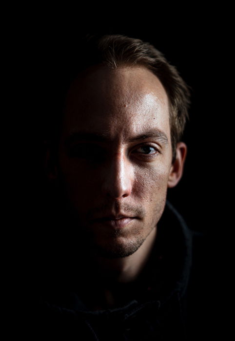 A shadowy photo of a man using a 1 light setup for portraits